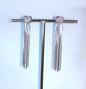 Orecchini "Heart Waterfall" in acciaio inox con design a cuore martellato con cascata di catenine sottili